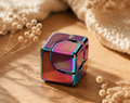 Multicolored fidget spinner object on a wooden surface with dried flowers